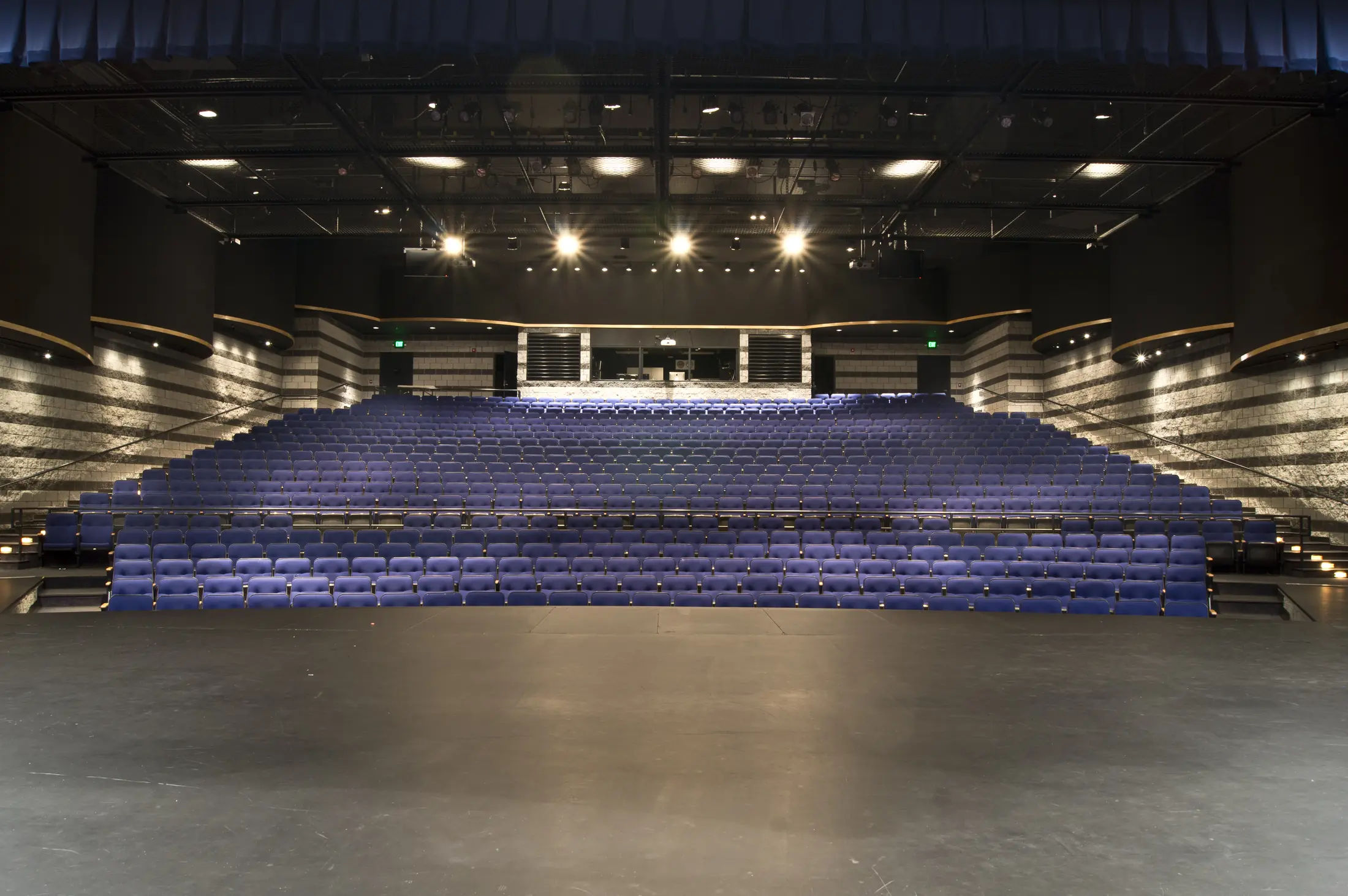 Walled Lake Central auditorium from the stage: blue seats rising to the booth